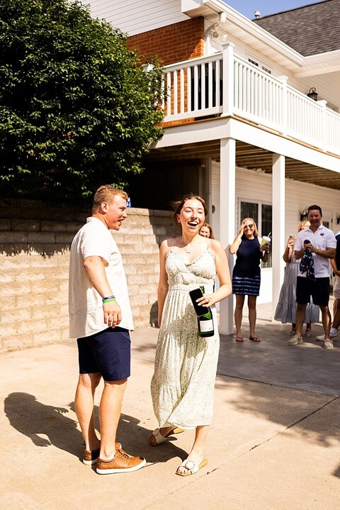Groom to be proposing during surprise wedding proposal at family home | Emotional reaction during surprise wedding proposal at family home in Missouri | Couple celebrating after surprise wedding proposal at family home | Portraits of newly engaged couple after surprise wedding proposal