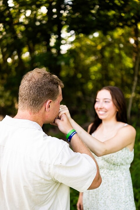 Groom to be proposing during surprise wedding proposal at family home | Emotional reaction during surprise wedding proposal at family home in Missouri | Couple celebrating after surprise wedding proposal at family home | Portraits of newly engaged couple after surprise wedding proposal