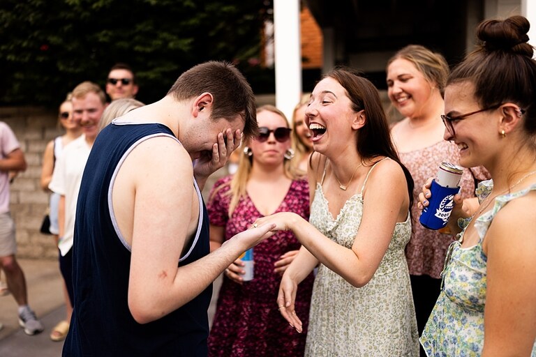 Groom to be proposing during surprise wedding proposal at family home | Emotional reaction during surprise wedding proposal at family home in Missouri | Couple celebrating after surprise wedding proposal at family home | Portraits of newly engaged couple after surprise wedding proposal