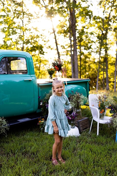 Mother and daughter laughing together during flower truck session in High Hill Missouri