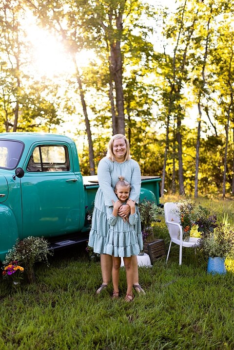 Mother and daughter laughing together during flower truck session in High Hill Missouri