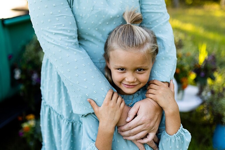 Mother and daughter laughing together during flower truck session in High Hill Missouri