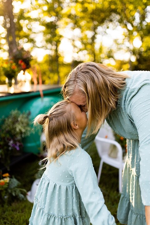 Mother and daughter laughing together during flower truck session in High Hill Missouri