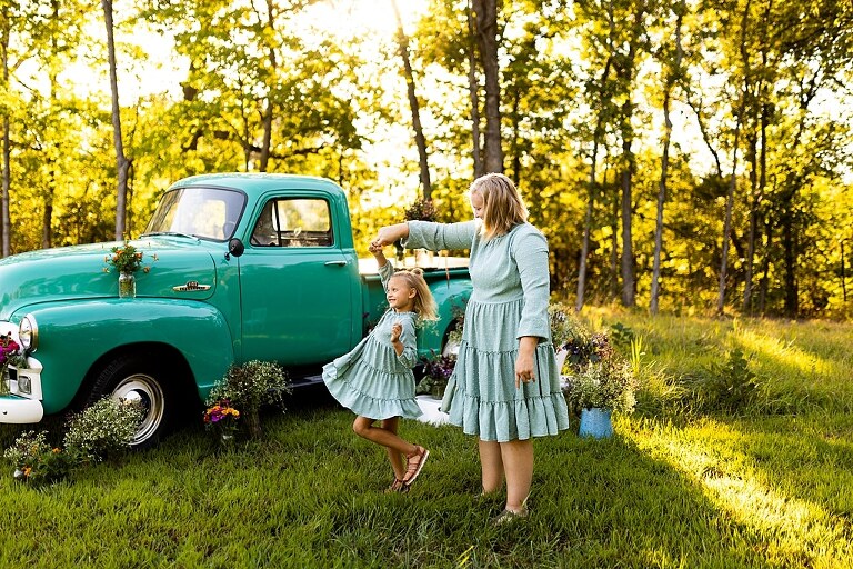 Mother and daughter laughing together during flower truck session in High Hill Missouri