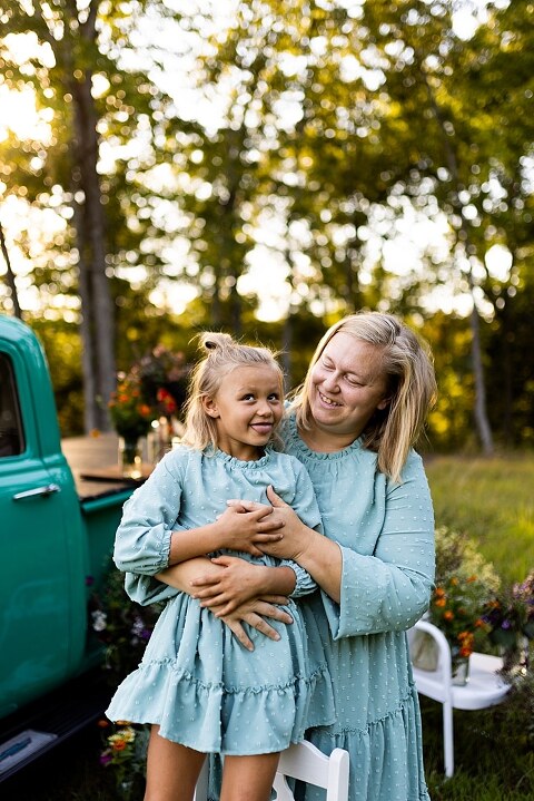 Mother and daughter laughing together during flower truck session in High Hill Missouri