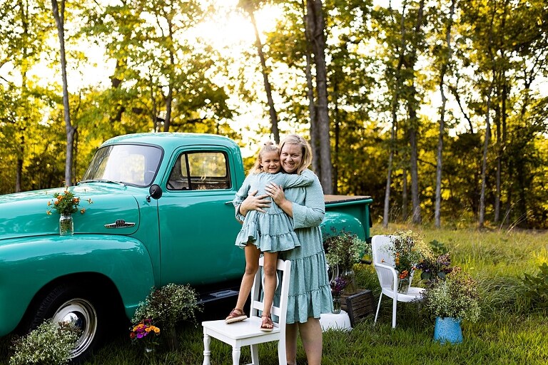 Mother and daughter laughing together during flower truck session in High Hill Missouri