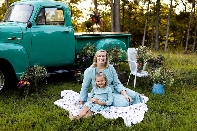 Mother and daughter laughing together during flower truck session in High Hill Missouri
