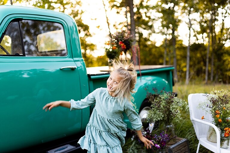 Mother and daughter laughing together during flower truck session in High Hill Missouri