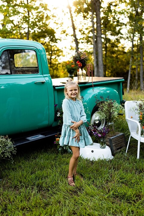Mother and daughter laughing together during flower truck session in High Hill Missouri