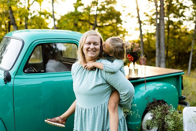 Mother and daughter laughing together during flower truck session in High Hill Missouri