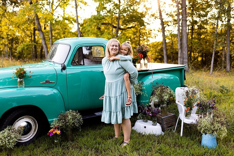 Mother and daughter laughing together during flower truck session in High Hill Missouri
