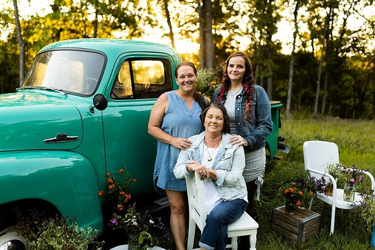 Family hugging with their mother during flower truck session in High Hill Missouri