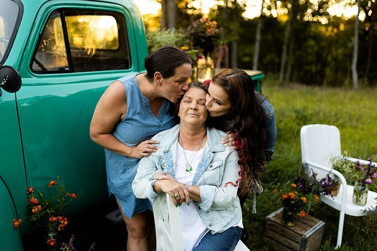 Family hugging with their mother during flower truck session in High Hill Missouri