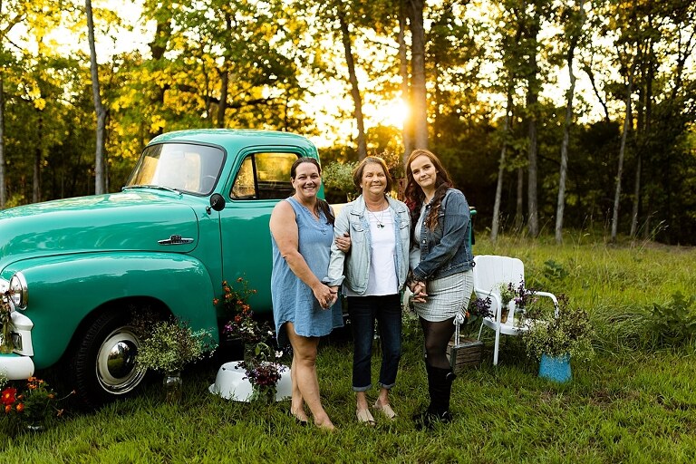 Family hugging with their mother during flower truck session in High Hill Missouri