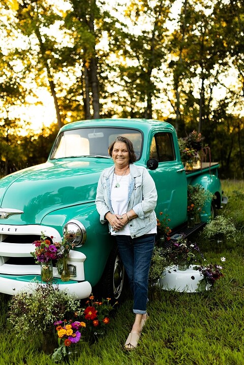 Family hugging with their mother during flower truck session in High Hill Missouri