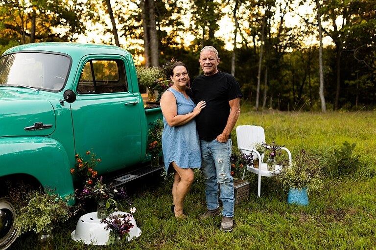 Family hugging with their mother during flower truck session in High Hill Missouri
