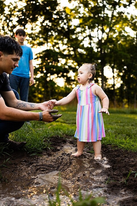 Playful family photo session in High Hill Missouri with mom and four kids enjoying bubbles, sprinkler fun, mud, and sunshine during summertime minis.