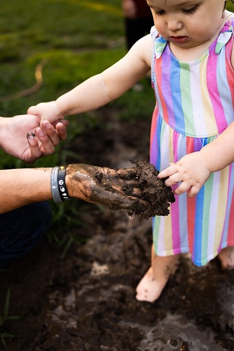 Playful family photo session in High Hill Missouri with mom and four kids enjoying bubbles, sprinkler fun, mud, and sunshine during summertime minis.