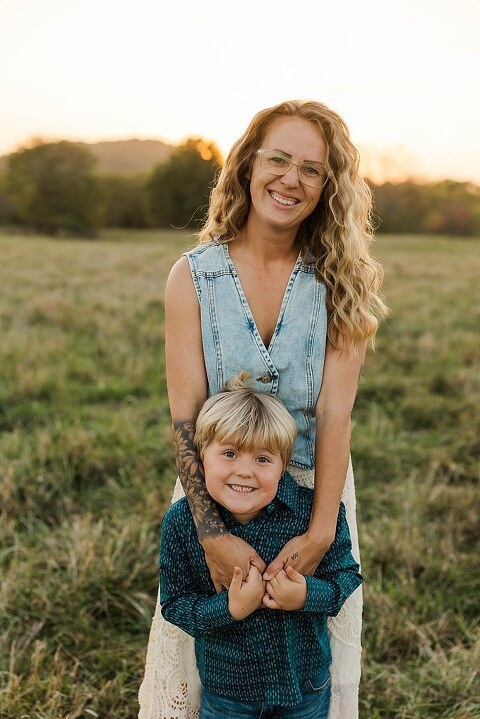 Family standing together in a warm country field during their 90’s style session.
Parents holding their kids with soft golden light behind them.
Family walking through a field during a country-inspired photo shoot.
Close-up of parents smiling during their session with Taylor Ligon Photography.
Kids laughing while standing between their parents in a sunny field.