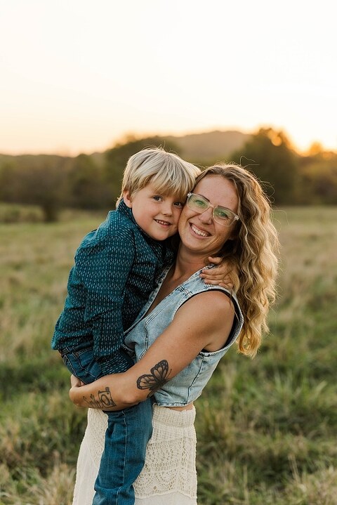 Family standing together in a warm country field during their 90’s style session.
Parents holding their kids with soft golden light behind them.
Family walking through a field during a country-inspired photo shoot.
Close-up of parents smiling during their session with Taylor Ligon Photography.
Kids laughing while standing between their parents in a sunny field.