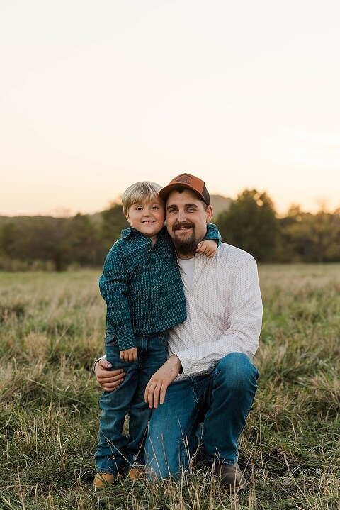 Family standing together in a warm country field during their 90’s style session.
Parents holding their kids with soft golden light behind them.
Family walking through a field during a country-inspired photo shoot.
Close-up of parents smiling during their session with Taylor Ligon Photography.
Kids laughing while standing between their parents in a sunny field.