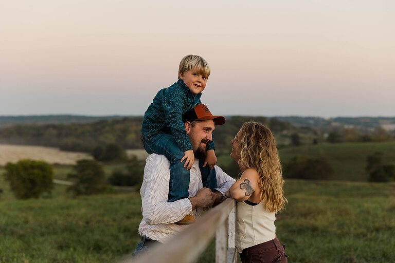 Family standing together in a warm country field during their 90’s style session.
Parents holding their kids with soft golden light behind them.
Family walking through a field during a country-inspired photo shoot.
Close-up of parents smiling during their session with Taylor Ligon Photography.
Kids laughing while standing between their parents in a sunny field.