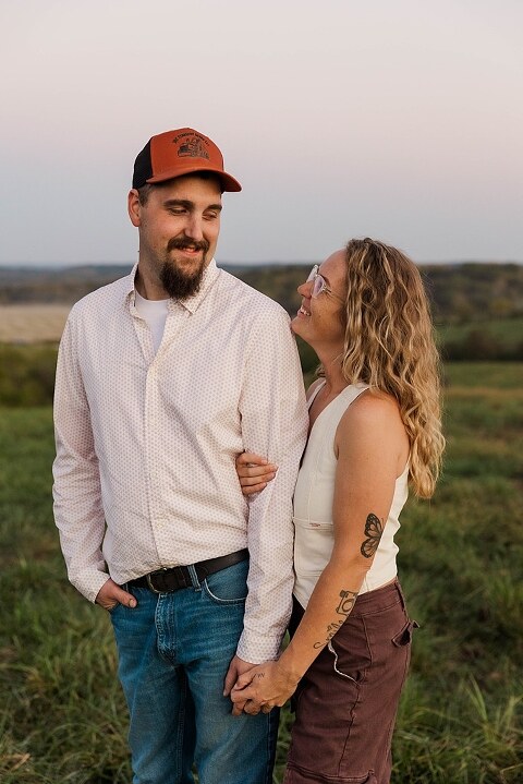 Family standing together in a warm country field during their 90’s style session.
Parents holding their kids with soft golden light behind them.
Family walking through a field during a country-inspired photo shoot.
Close-up of parents smiling during their session with Taylor Ligon Photography.
Kids laughing while standing between their parents in a sunny field.