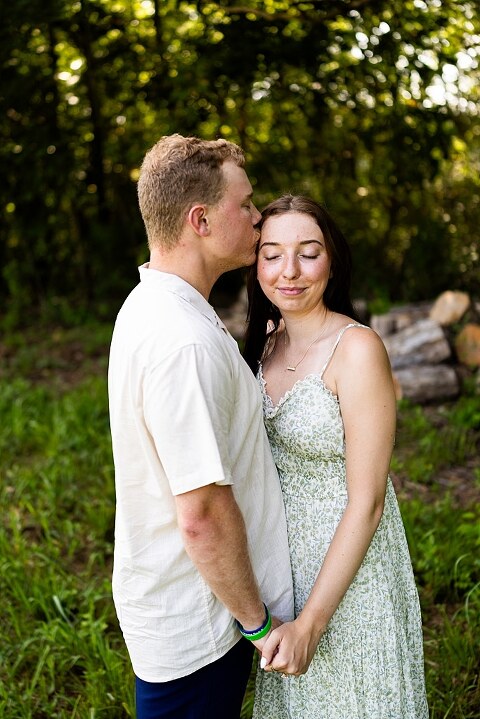 Groom to be proposing during surprise wedding proposal at family home | Emotional reaction during surprise wedding proposal at family home in Missouri | Couple celebrating after surprise wedding proposal at family home | Portraits of newly engaged couple after surprise wedding proposal
