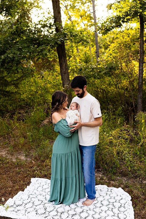 New parents holding their newborn girl outside in soft September light
Mother cradling newborn during an outdoor in home lifestyle session
Father smiling while holding baby girl in shaded backyard
Family photo with their dog photobombing in the background
Newborn resting peacefully with a curious kitty peeking nearby