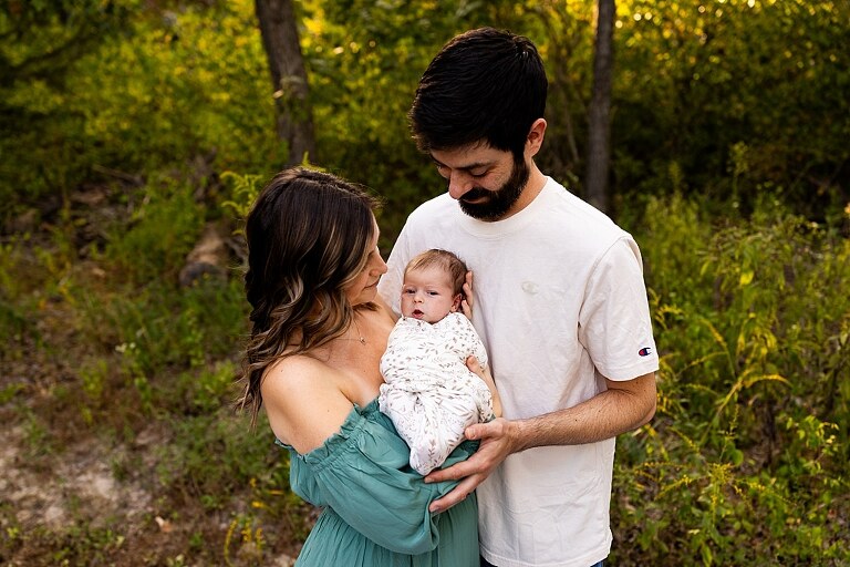 New parents holding their newborn girl outside in soft September light
Mother cradling newborn during an outdoor in home lifestyle session
Father smiling while holding baby girl in shaded backyard
Family photo with their dog photobombing in the background
Newborn resting peacefully with a curious kitty peeking nearby