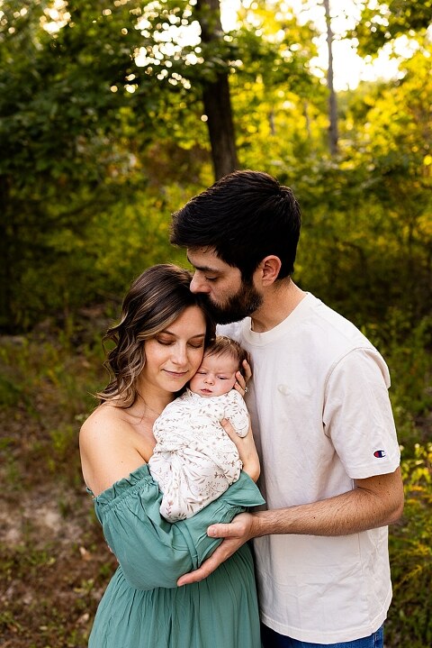 New parents holding their newborn girl outside in soft September light
Mother cradling newborn during an outdoor in home lifestyle session
Father smiling while holding baby girl in shaded backyard
Family photo with their dog photobombing in the background
Newborn resting peacefully with a curious kitty peeking nearby
