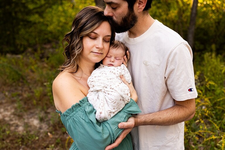 New parents holding their newborn girl outside in soft September light
Mother cradling newborn during an outdoor in home lifestyle session
Father smiling while holding baby girl in shaded backyard
Family photo with their dog photobombing in the background
Newborn resting peacefully with a curious kitty peeking nearby