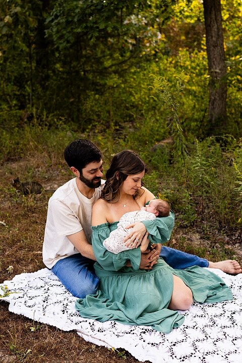 New parents holding their newborn girl outside in soft September light
Mother cradling newborn during an outdoor in home lifestyle session
Father smiling while holding baby girl in shaded backyard
Family photo with their dog photobombing in the background
Newborn resting peacefully with a curious kitty peeking nearby