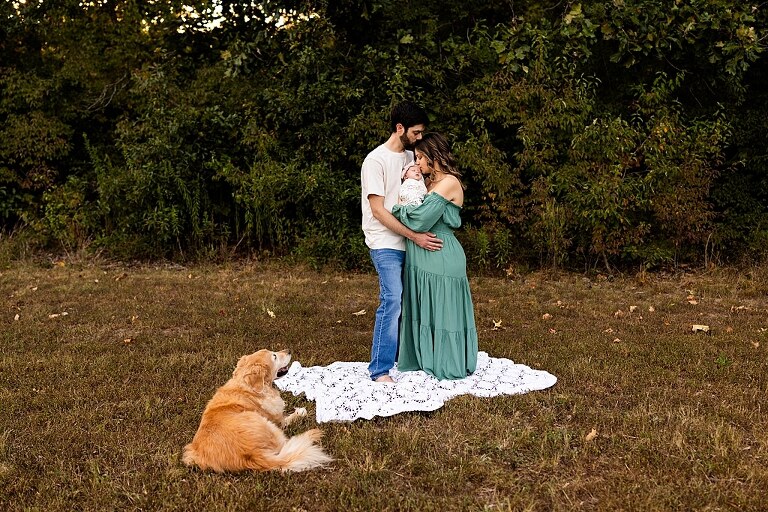 New parents holding their newborn girl outside in soft September light
Mother cradling newborn during an outdoor in home lifestyle session
Father smiling while holding baby girl in shaded backyard
Family photo with their dog photobombing in the background
Newborn resting peacefully with a curious kitty peeking nearby
