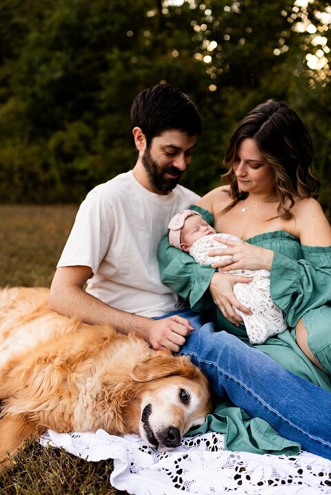 New parents holding their newborn girl outside in soft September light
Mother cradling newborn during an outdoor in home lifestyle session
Father smiling while holding baby girl in shaded backyard
Family photo with their dog photobombing in the background
Newborn resting peacefully with a curious kitty peeking nearby