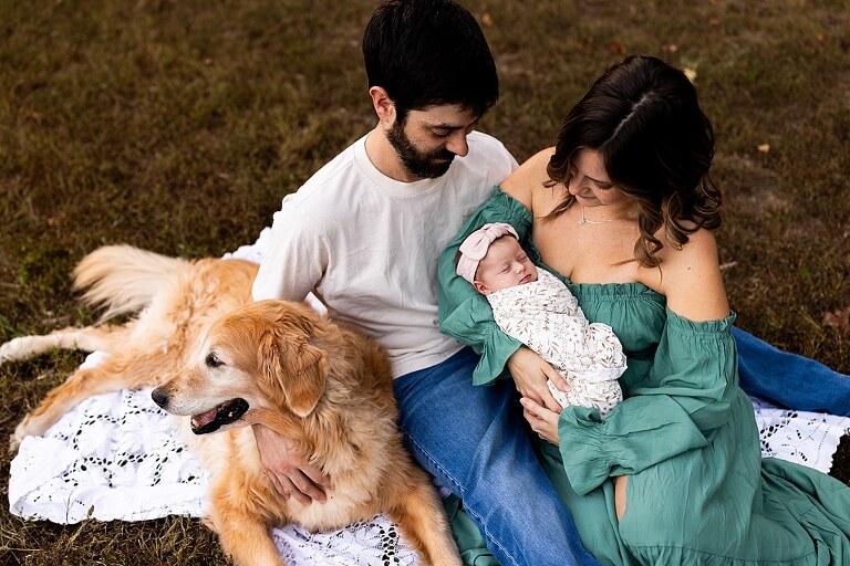 New parents holding their newborn girl outside in soft September light
Mother cradling newborn during an outdoor in home lifestyle session
Father smiling while holding baby girl in shaded backyard
Family photo with their dog photobombing in the background
Newborn resting peacefully with a curious kitty peeking nearby