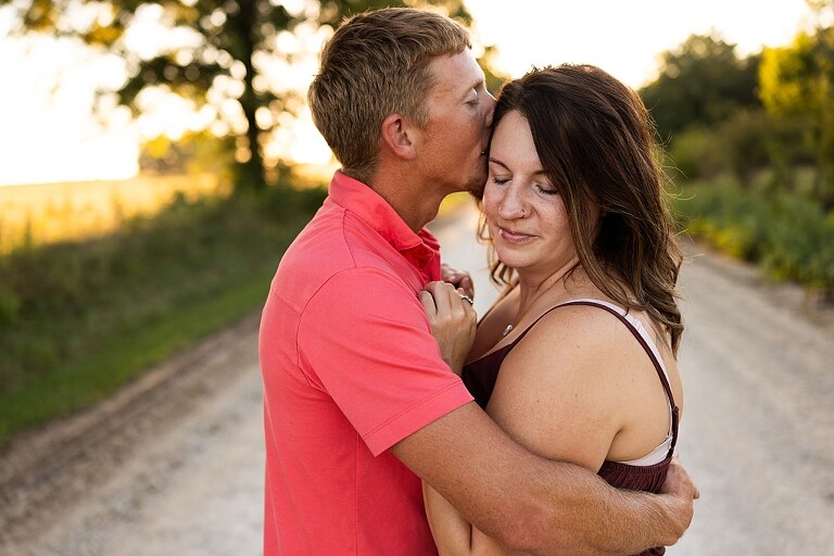 Family walking together through a field in High Hill Missouri
Parents smiling at their child while standing on a gravel road
Child laughing and making a silly face during a family session
Family holding hands in tall grass with warm evening light
Parents hugging their child while standing on a quiet country road