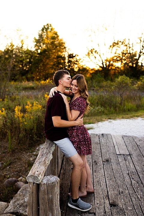 Tyler and Grace standing on a sunlit path at Towne Park during their engagement session.
Couple laughing together in an open field at Towne Park.
Tyler and Grace holding hands along a wooded trail with soft golden light behind them.
Close–up of the couple smiling at each other during their engagement session.
Engagement ring photo taken at Towne Park with natural greenery in the background.