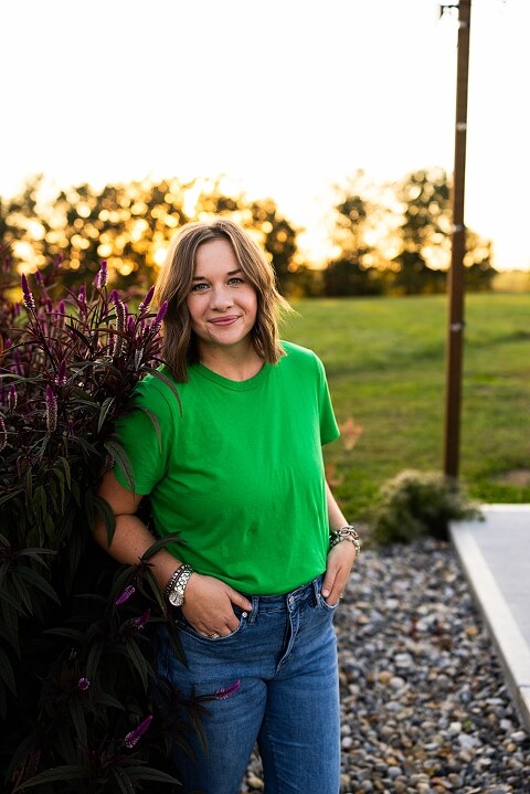 Aimie standing in her flower garden in High Hill Missouri surrounded by colorful blooms.
Close–up of Aimie gently holding freshly cut flowers from her garden.
Wide view of the flower farm with rows of vibrant summer flowers.
Aimie smiling while arranging flowers during her garden session.
Hands holding a bouquet of freshly picked flowers in soft natural light.