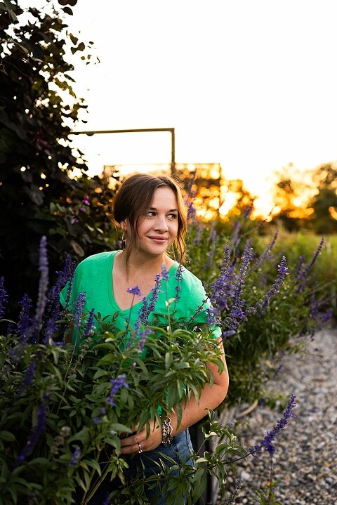 Aimie standing in her flower garden in High Hill Missouri surrounded by colorful blooms.
Close–up of Aimie gently holding freshly cut flowers from her garden.
Wide view of the flower farm with rows of vibrant summer flowers.
Aimie smiling while arranging flowers during her garden session.
Hands holding a bouquet of freshly picked flowers in soft natural light.