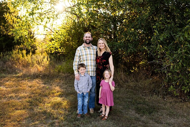 Family standing together at Towne Park during a golden afternoon.
Kids smiling and posing on a gravel path at Towne Park.
Parents laughing while holding their children during the session.
Children running through a sunny field at Towne Park.
Family cuddled together on a grassy patch beneath tall trees.