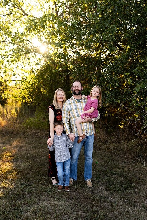Family standing together at Towne Park during a golden afternoon.
Kids smiling and posing on a gravel path at Towne Park.
Parents laughing while holding their children during the session.
Children running through a sunny field at Towne Park.
Family cuddled together on a grassy patch beneath tall trees.