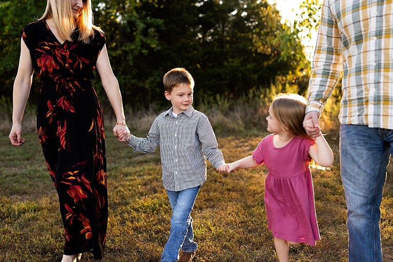 Family standing together at Towne Park during a golden afternoon.
Kids smiling and posing on a gravel path at Towne Park.
Parents laughing while holding their children during the session.
Children running through a sunny field at Towne Park.
Family cuddled together on a grassy patch beneath tall trees.