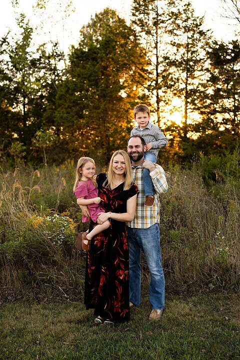 Family standing together at Towne Park during a golden afternoon.
Kids smiling and posing on a gravel path at Towne Park.
Parents laughing while holding their children during the session.
Children running through a sunny field at Towne Park.
Family cuddled together on a grassy patch beneath tall trees.