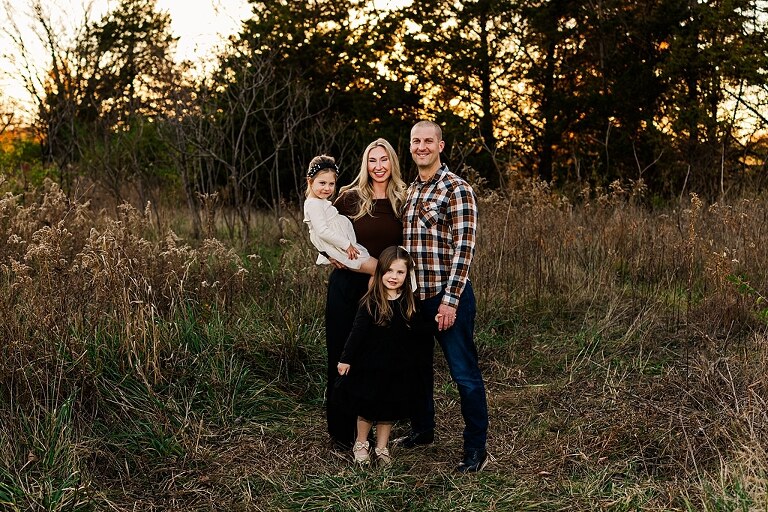 Family standing together at Towne Park in Foristell Missouri during golden hour.
Parents holding their children while laughing in an open field.
Family walking along a tree-lined path at Towne Park.
Kids smiling while standing between their parents during the session.
Close-up of Rob and Taylor hugging with soft light behind them.