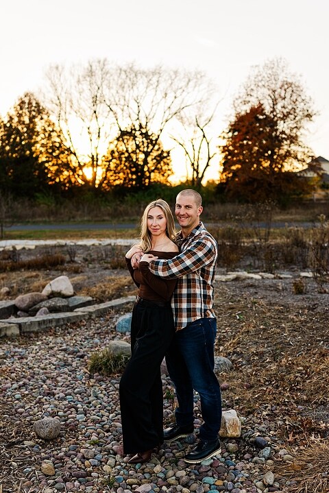 Family standing together at Towne Park in Foristell Missouri during golden hour.
Parents holding their children while laughing in an open field.
Family walking along a tree-lined path at Towne Park.
Kids smiling while standing between their parents during the session.
Close-up of Rob and Taylor hugging with soft light behind them.