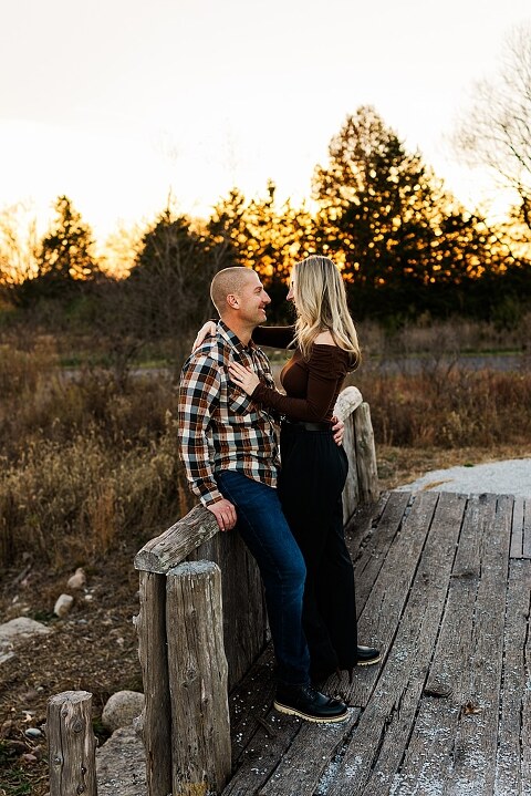 Family standing together at Towne Park in Foristell Missouri during golden hour.
Parents holding their children while laughing in an open field.
Family walking along a tree-lined path at Towne Park.
Kids smiling while standing between their parents during the session.
Close-up of Rob and Taylor hugging with soft light behind them.