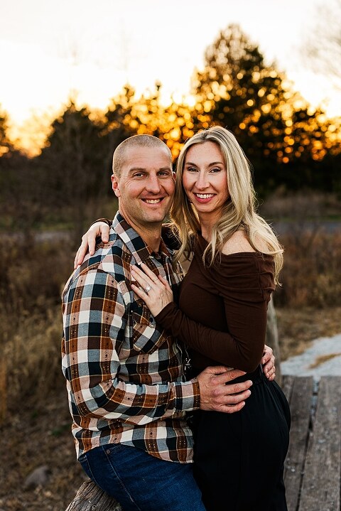 Family standing together at Towne Park in Foristell Missouri during golden hour.
Parents holding their children while laughing in an open field.
Family walking along a tree-lined path at Towne Park.
Kids smiling while standing between their parents during the session.
Close-up of Rob and Taylor hugging with soft light behind them.
