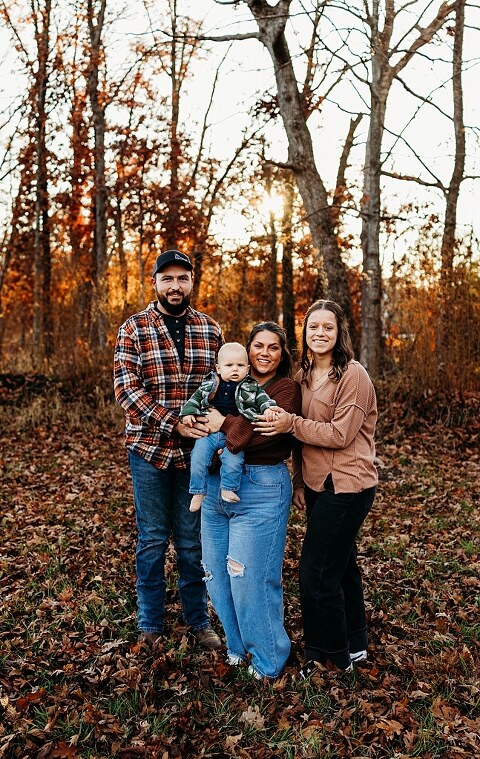 Family holding their baby during a session in High Hill Missouri.
Parents kissing their smiling little boy in warm natural light.
Baby laughing while sitting with his parents on a country path.
Family walking together through a grassy field.
Close-up of baby boy smiling during his milestone session.