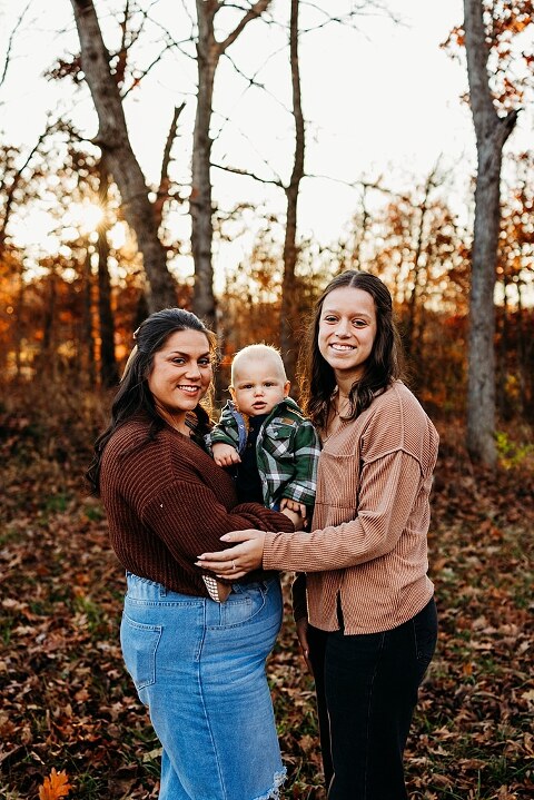 Family holding their baby during a session in High Hill Missouri.
Parents kissing their smiling little boy in warm natural light.
Baby laughing while sitting with his parents on a country path.
Family walking together through a grassy field.
Close-up of baby boy smiling during his milestone session.